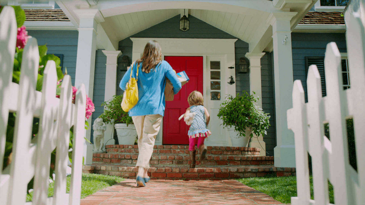 Woman with child walking up to front porch